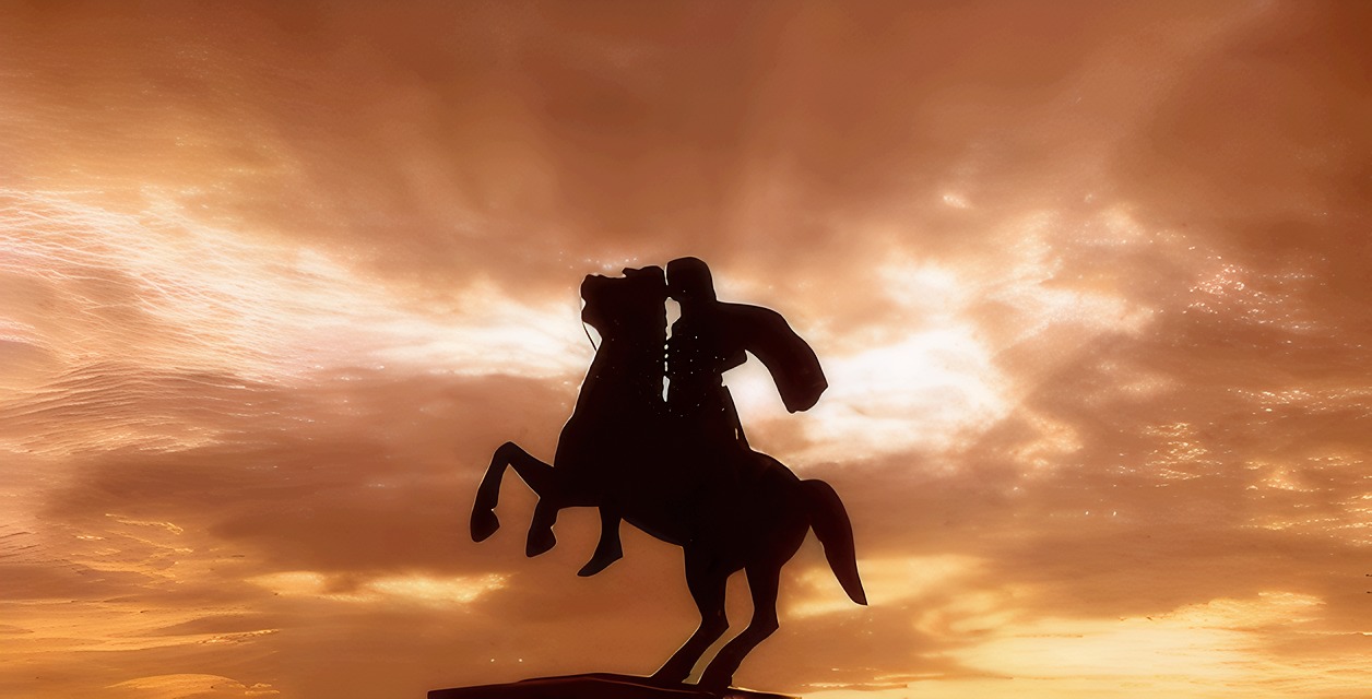 A rider on horseback silhouetted against the sunset